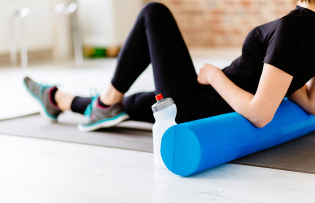 fitness club member stretching on a yoga mat