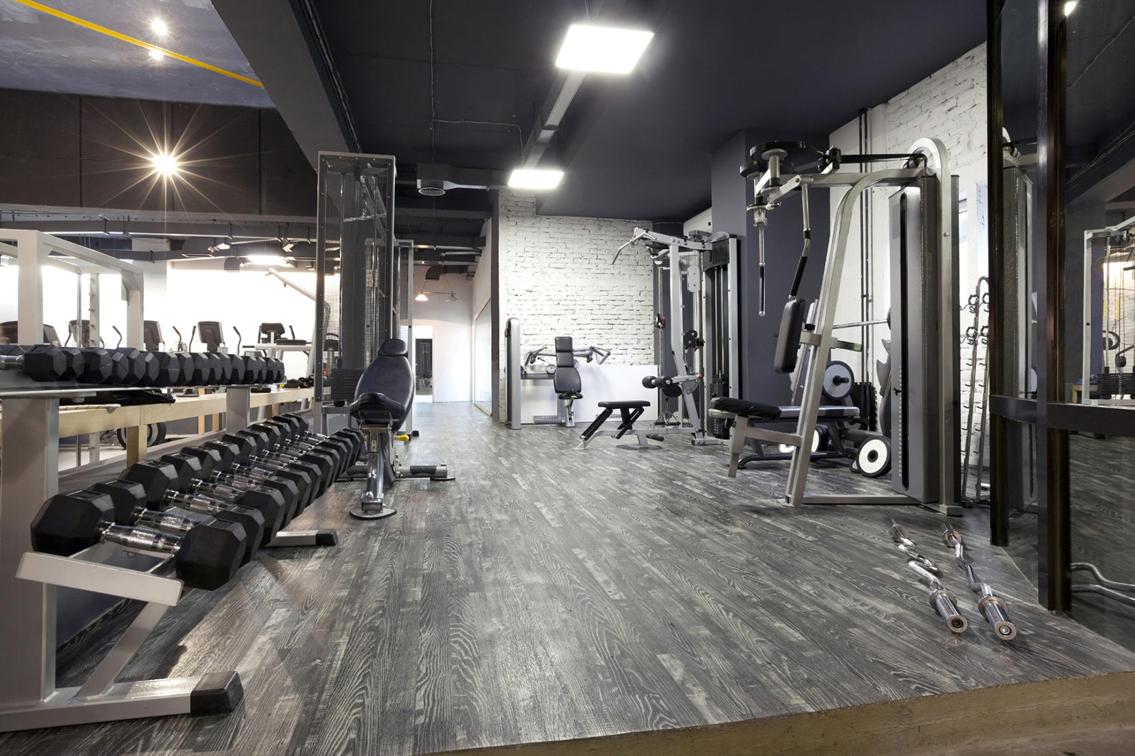 gym with racks of weights and machines with modern decor and design